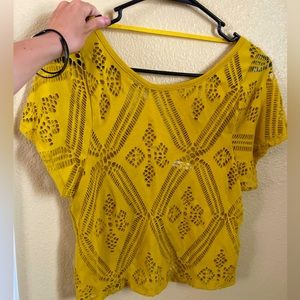 Mustard yellow cut out crop top with an open style back
